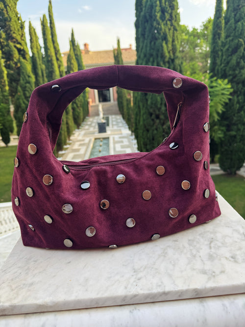 Aubergine Élise Bag – dameshandtas met zilveren studs van Gabianna Fashion, gefotografeerd in een elegante tuinomgeving